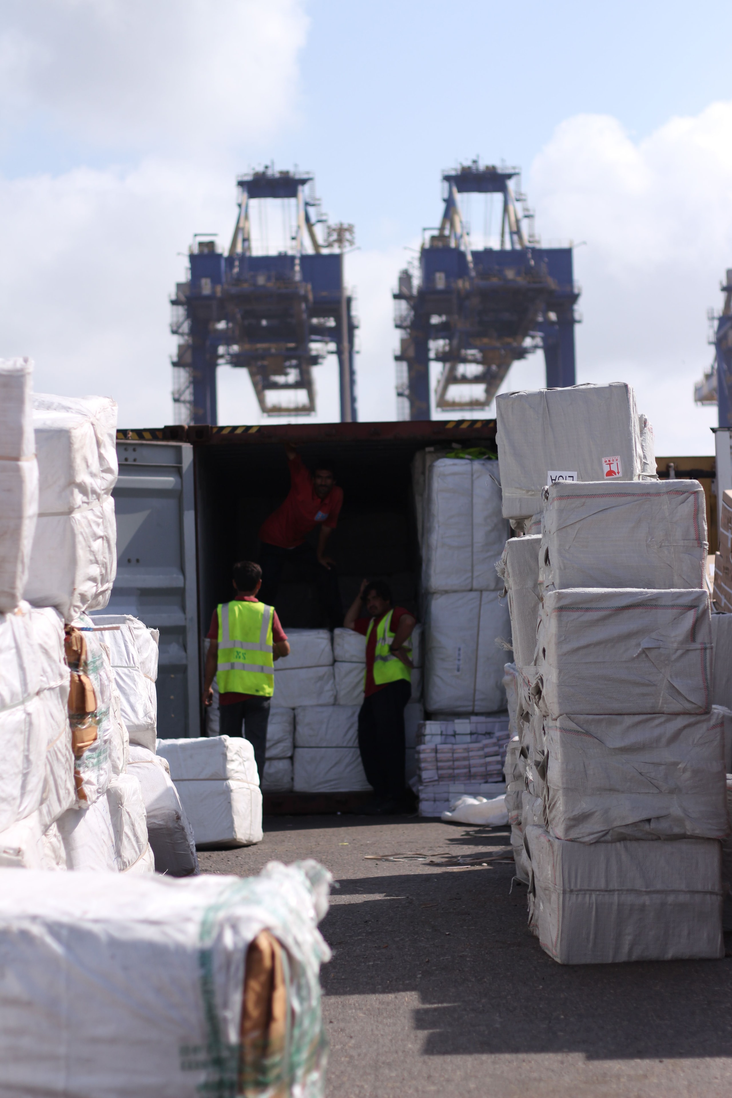 Port workers loading cargo containers — AAI Grains export operations at Nigerian seaport